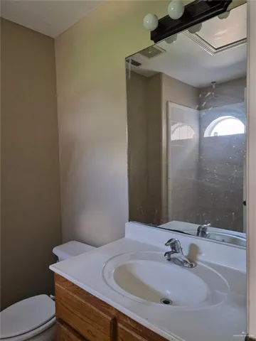 a bathroom with a sink toilet and mirror