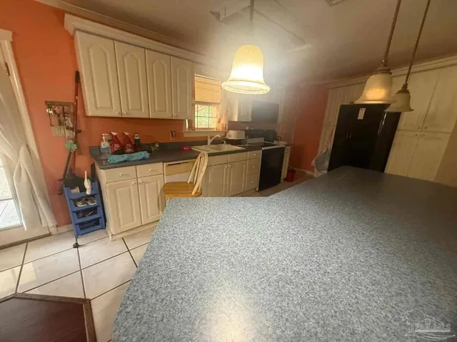 a spacious bedroom with a bed and a lamp