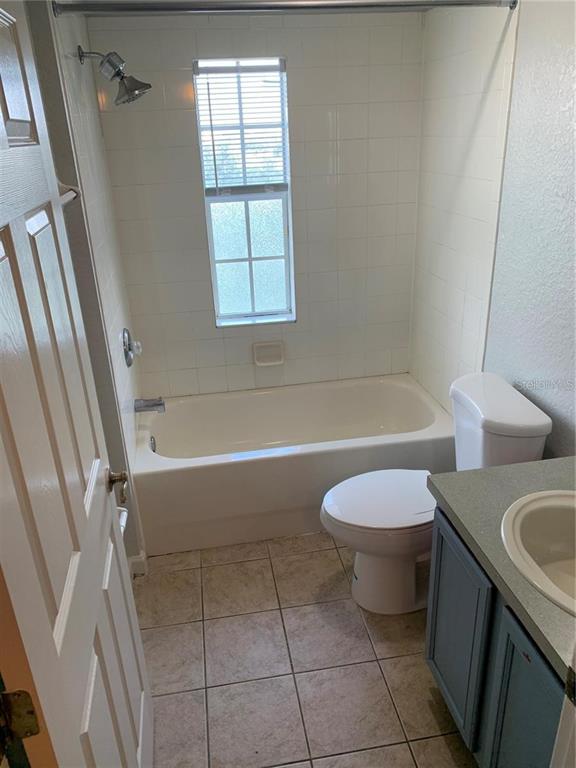 3001 Laurel Run Lane, Unit 301 Kissimmee, FL 34741 - Photo 16 of 17 a bathroom with a sink a toilet and tub
