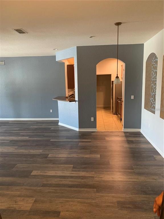 3001 Laurel Run Lane, Unit 301 Kissimmee, FL 34741 - Photo 4 of 17 a view of a room with wooden floor and door