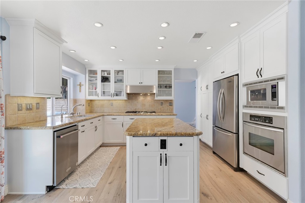 3843 San Gabriel Street Simi Valley, CA 93063 - Photo 3 of 52 a kitchen with stainless steel appliances granite countertop a refrigerator and a stove top oven