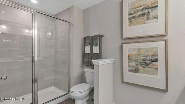 a bathroom with a shower and a toilet