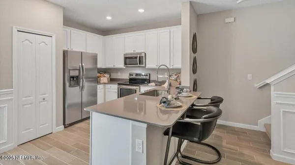 a kitchen with refrigerator cabinets and dining table