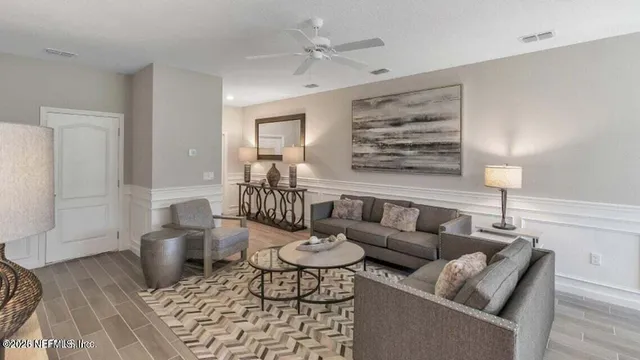a living room with furniture and wooden floor