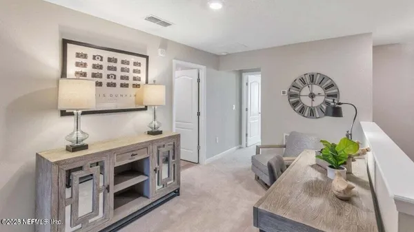 a living room with stainless steel appliances furniture a stove and a window
