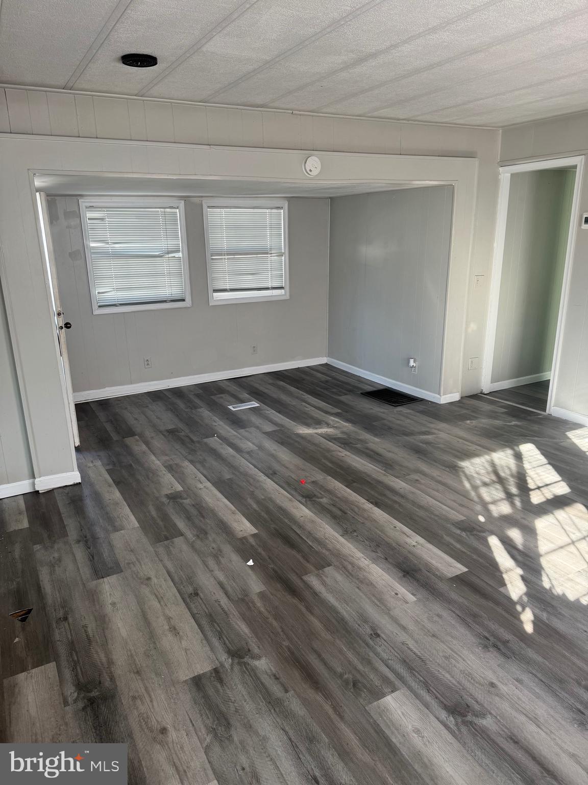 13318 Colonial Road Ocean City, MD 21842 - Photo 5 of 13 a view of a livingroom with wooden floor and window
