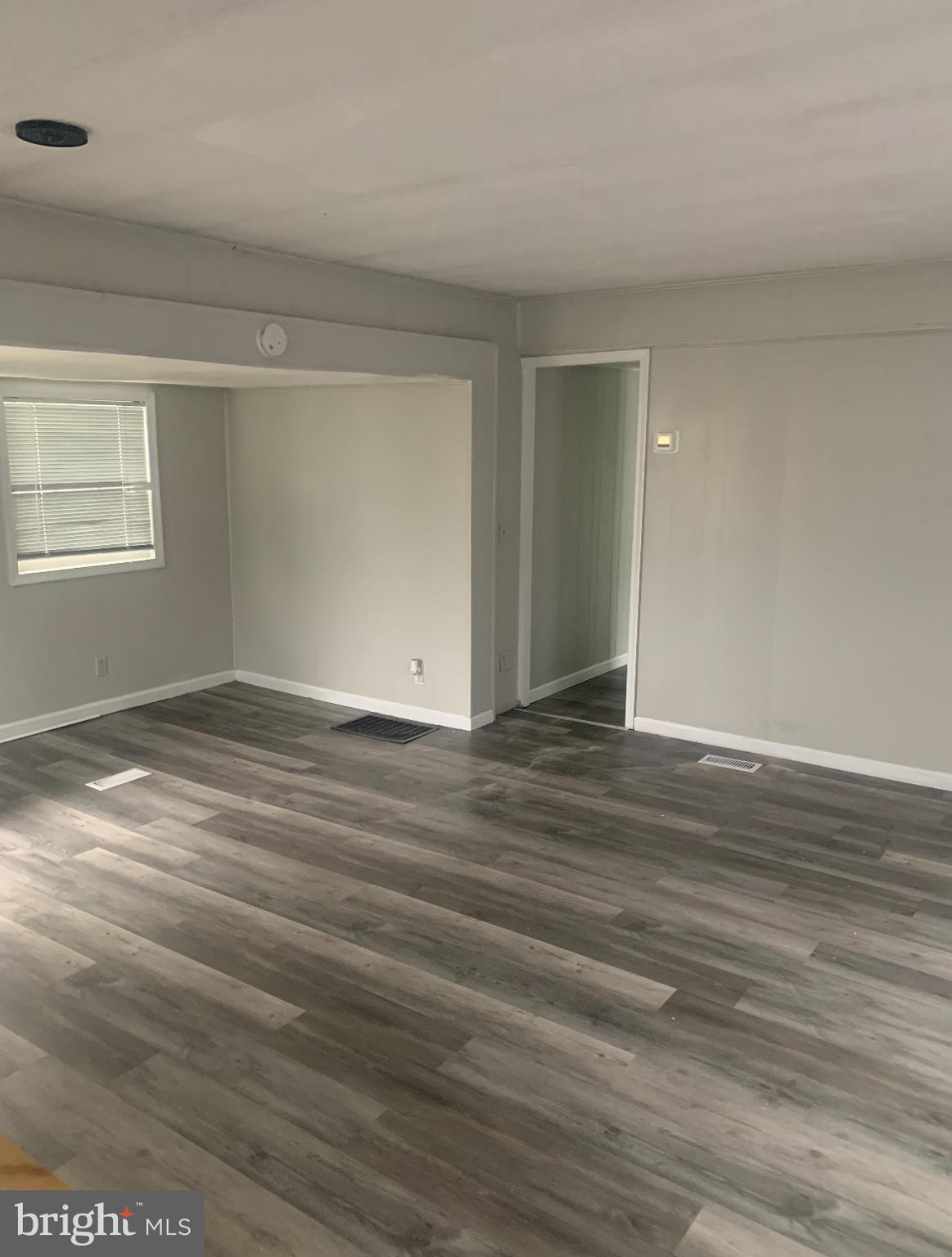 13318 Colonial Road Ocean City, MD 21842 - Photo 6 of 13 wooden floor in an empty room