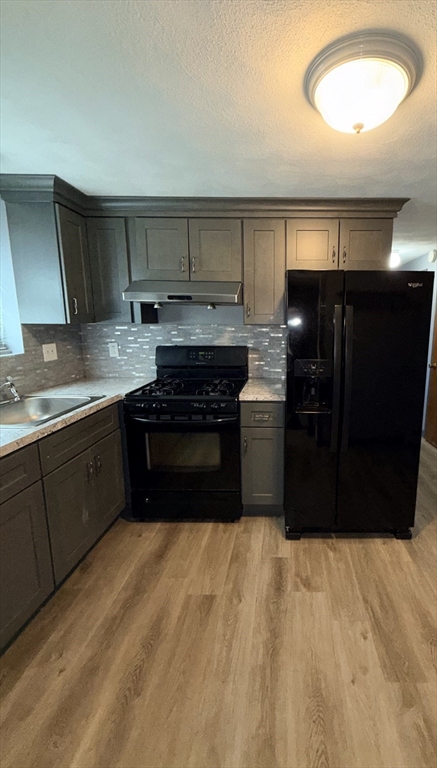 43 Haith Street, Unit B Revere, MA 02151 - Photo 3 of 9 a kitchen with a sink a stove and cabinets
