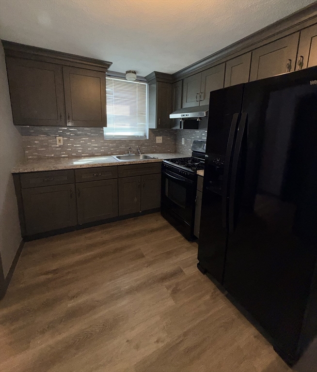 43 Haith Street, Unit B Revere, MA 02151 - Photo 4 of 9 a kitchen with a refrigerator and cabinets
