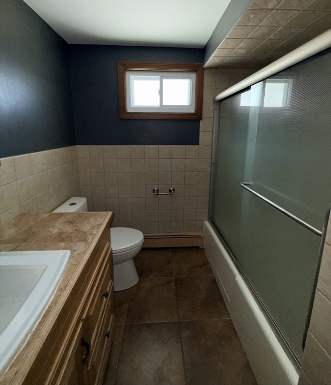 43 Haith Street, Unit B Revere, MA 02151 - Photo 8 of 9 a bathroom with a granite countertop sink toilet and shower