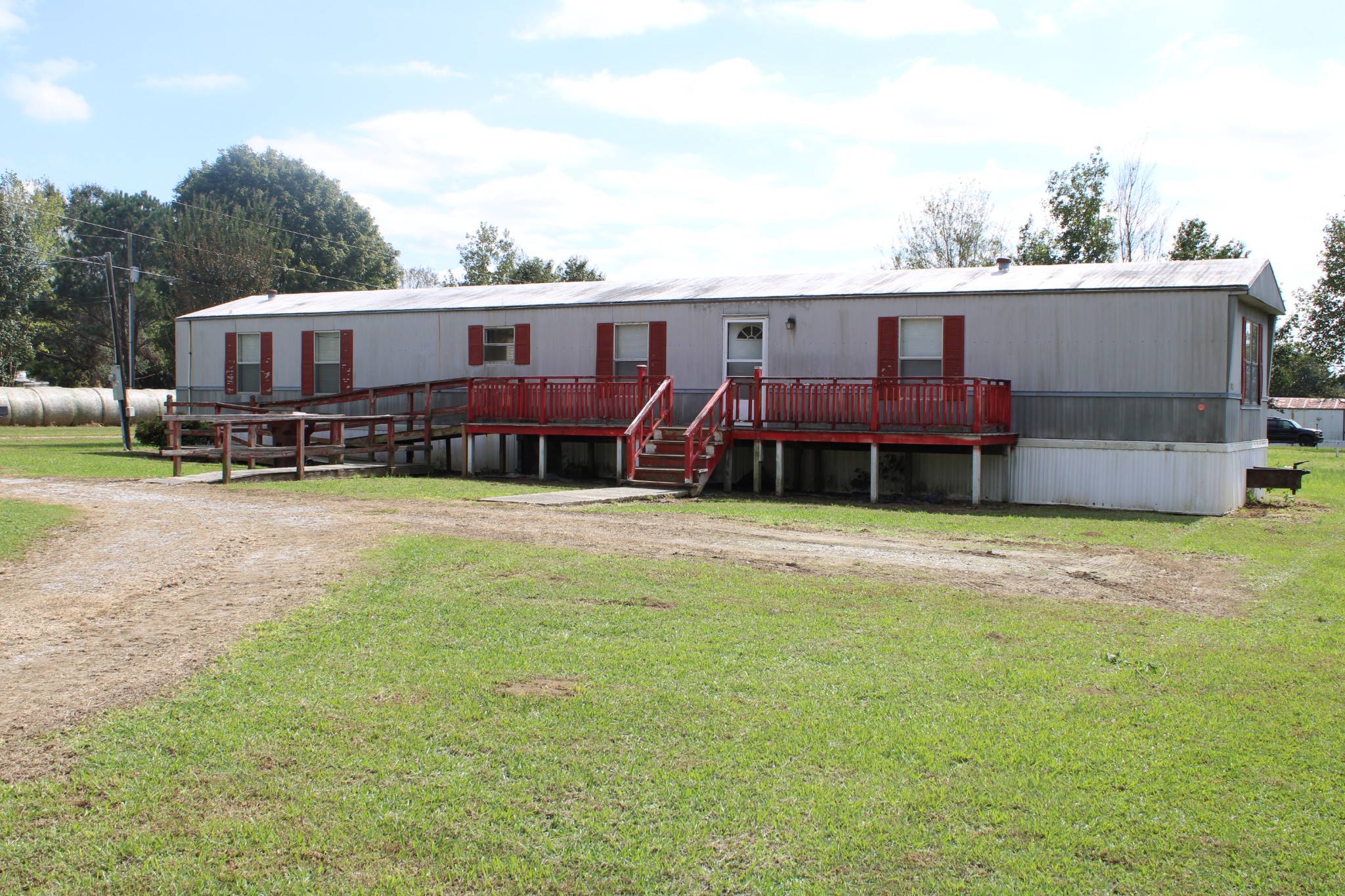 a view of a house with a yard and sitting area