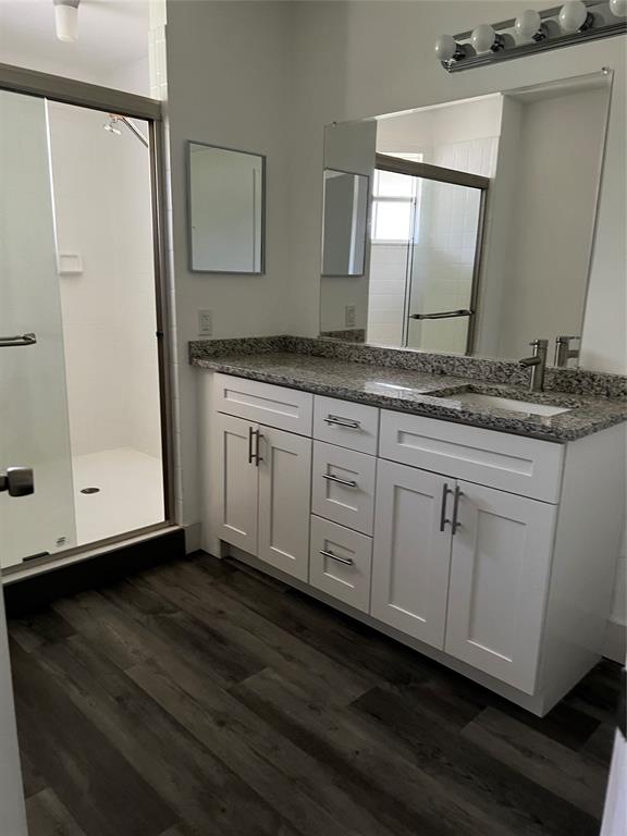6596 Via Regina, Unit 6596 Boca Raton, FL 33433 - Photo 14 of 16 a bathroom with a granite countertop sink and a mirror