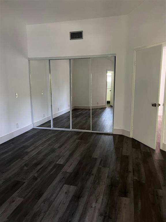 6596 Via Regina, Unit 6596 Boca Raton, FL 33433 - Photo 10 of 16 a view of an empty room with wooden floor and a window