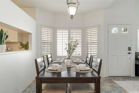 a view of a dining room with furniture window and outside view