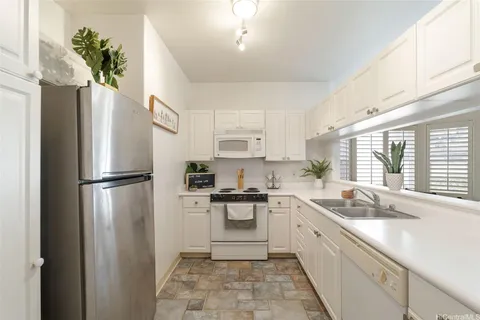 a kitchen with stainless steel appliances a refrigerator sink and cabinets