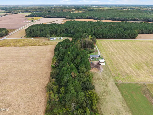 an aerial view of a house with a yard and lake view