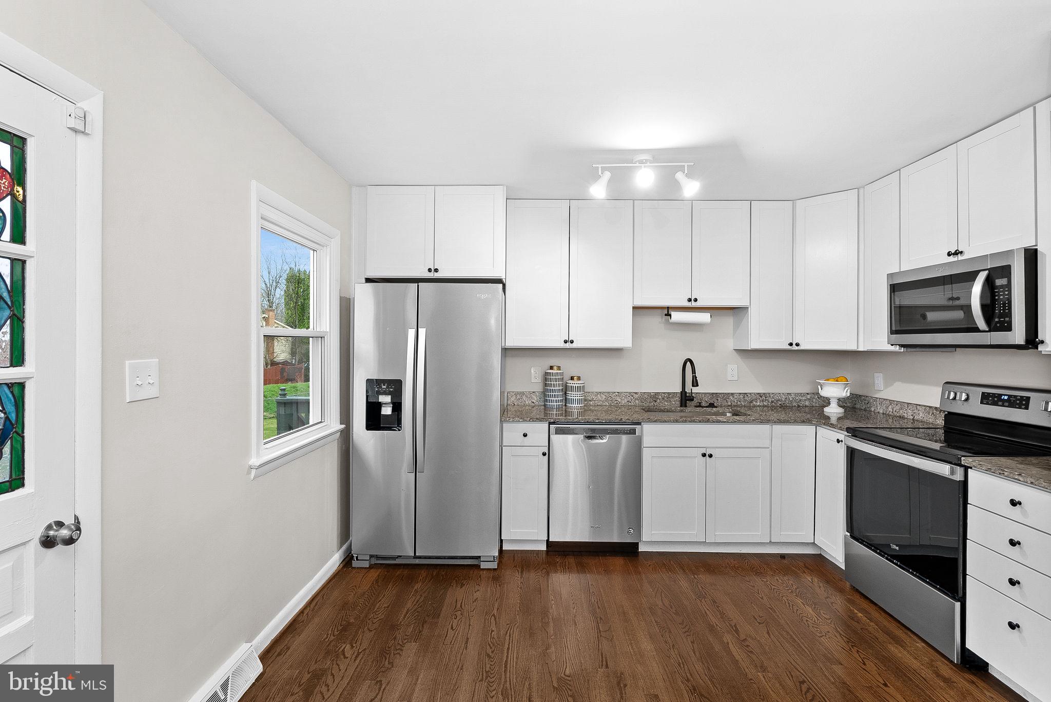 647 Battle Avenue Winchester, VA 22601 - Photo 14 of 44 a kitchen with granite countertop a refrigerator stove and sink
