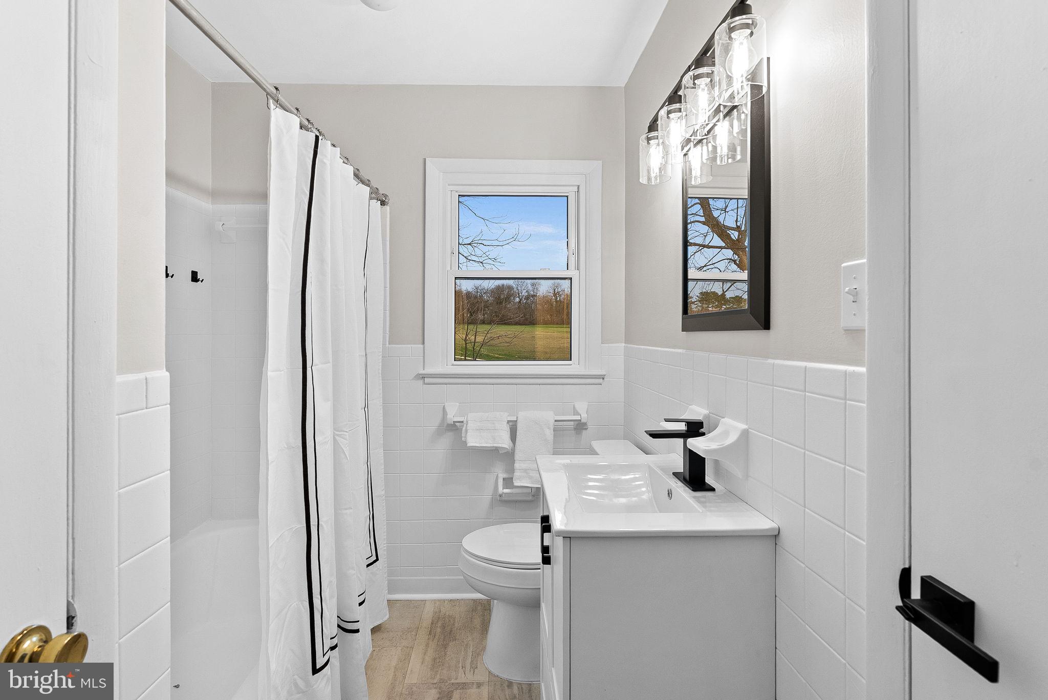 647 Battle Avenue Winchester, VA 22601 - Photo 24 of 44 a bathroom with a sink toilet and mirror
