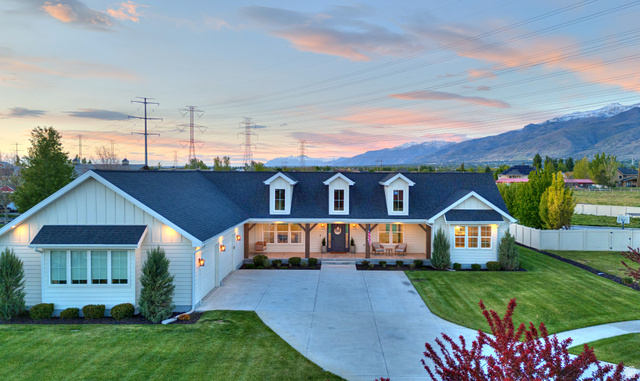 1952 South Comanche Circle Farmington, UT 84025 - Photo 1 of 52 View of front facade featuring covered porch, roof with shingles, board and batten siding, driveway, and a mountain view