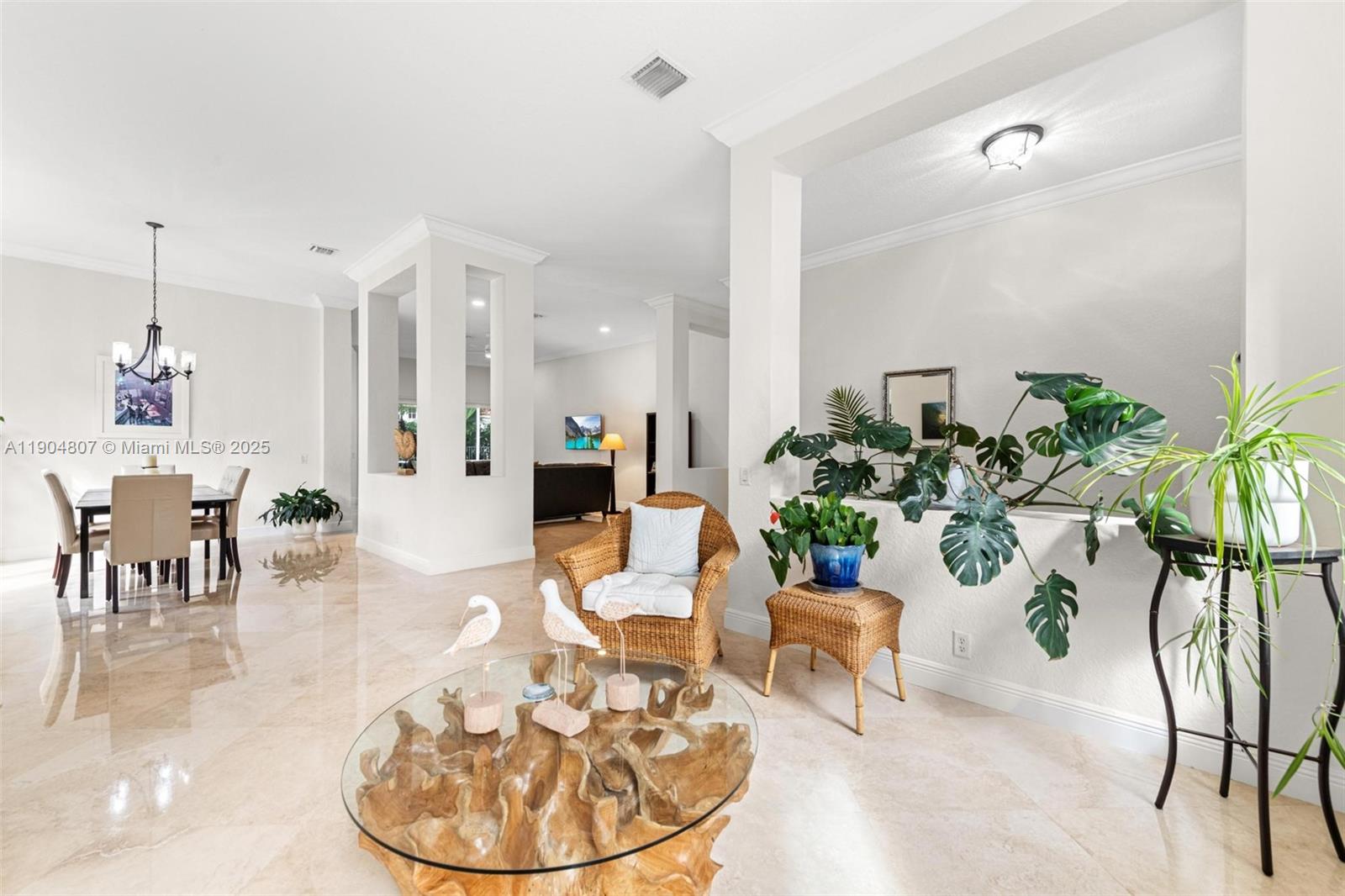1967 Timberline Road Weston, FL 33327 - Photo 11 of 56 a living room with furniture and a chandelier
