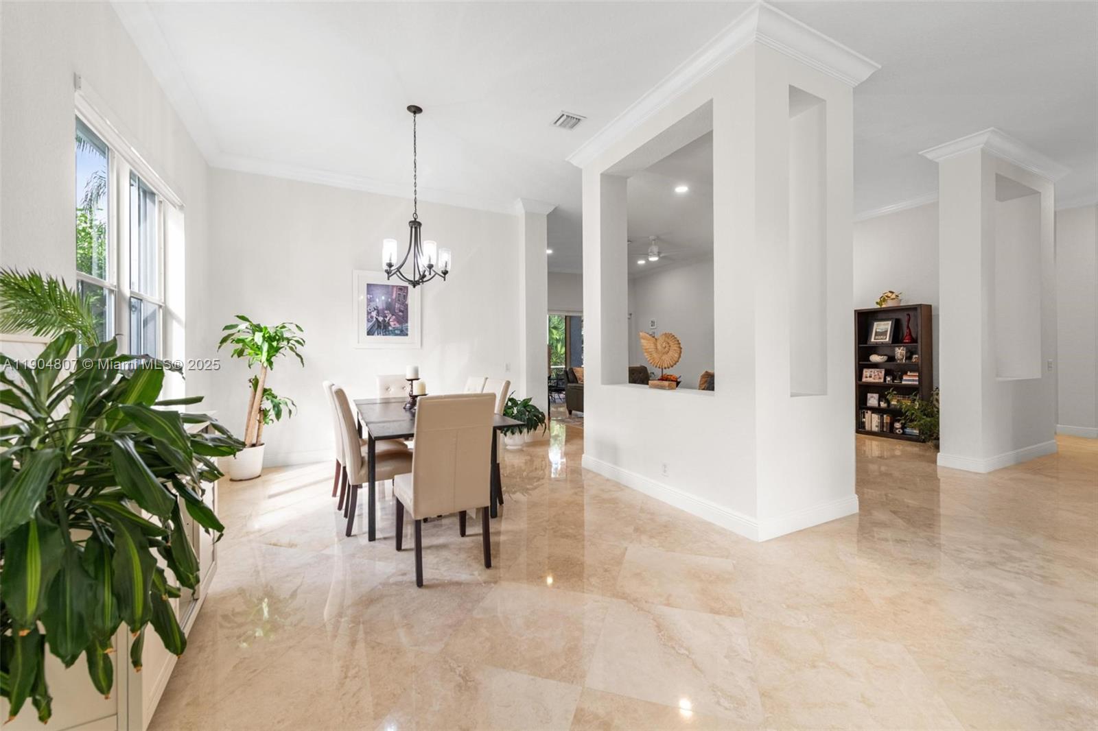1967 Timberline Road Weston, FL 33327 - Photo 13 of 56 a dining room with furniture and a chandelier