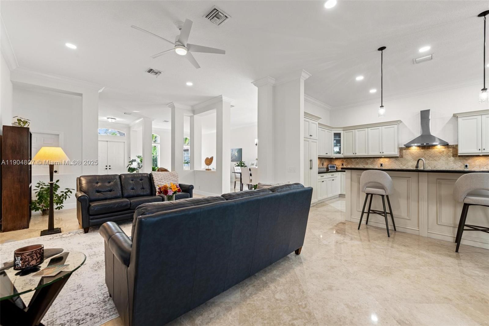 1967 Timberline Road Weston, FL 33327 - Photo 20 of 56 a kitchen with stainless steel appliances kitchen island granite countertop a stove a sink a refrigerator and a dining table with wooden floor