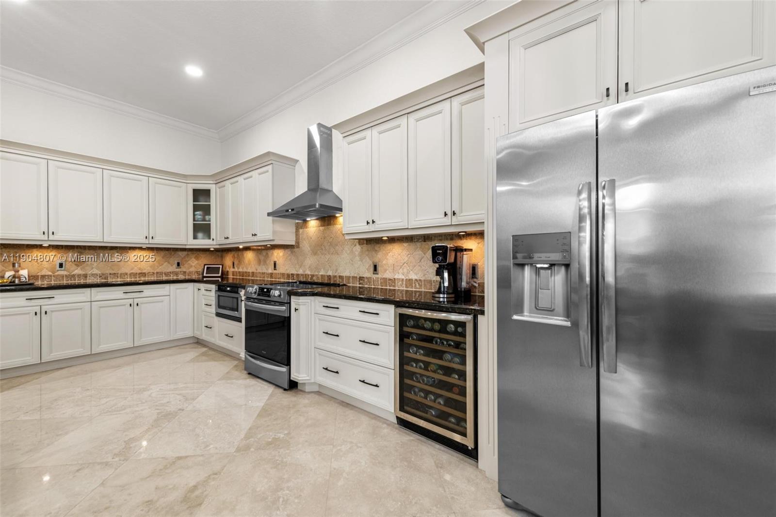 1967 Timberline Road Weston, FL 33327 - Photo 22 of 56 a kitchen with granite countertop a refrigerator stove top oven and cabinets