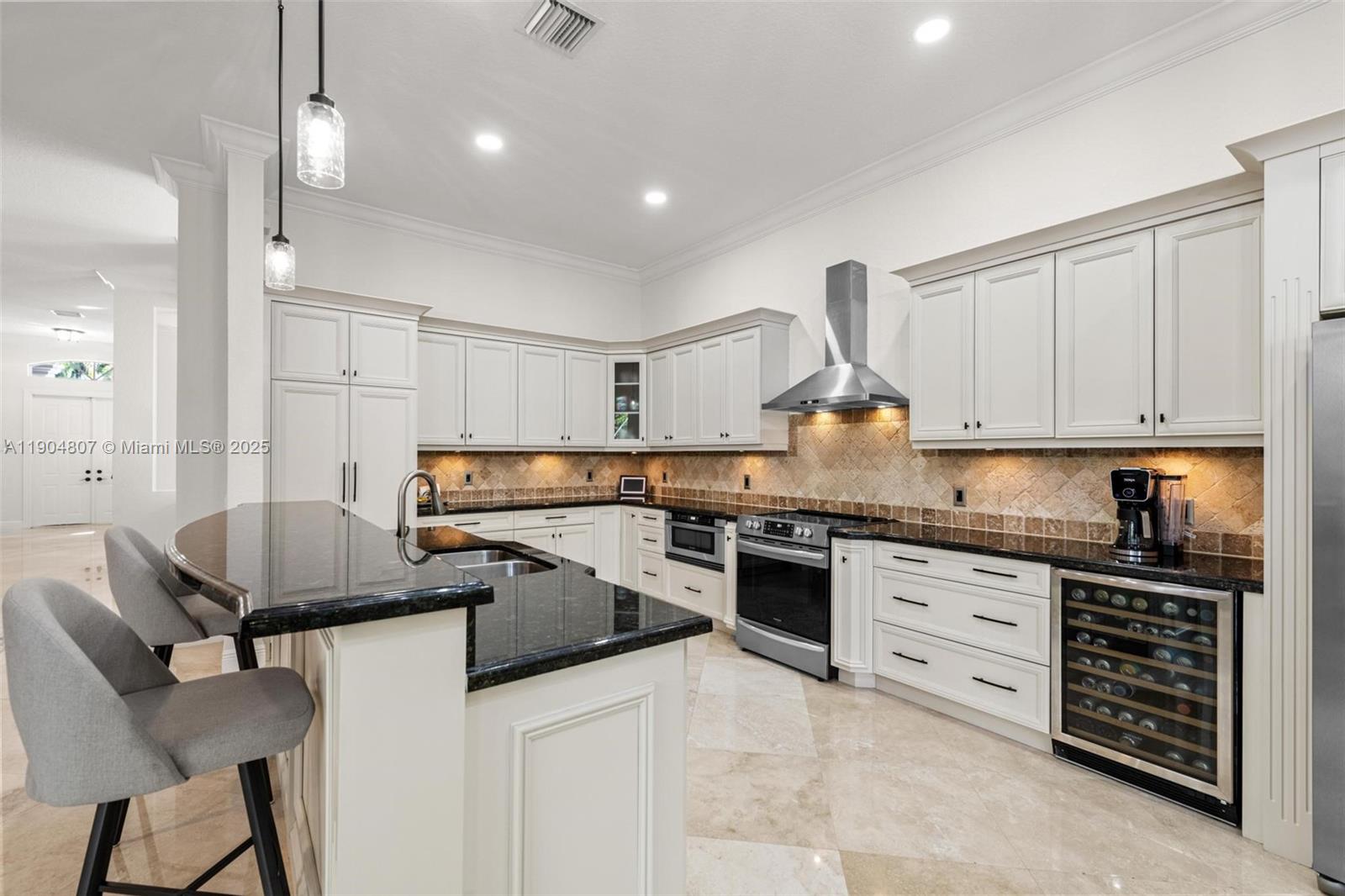 1967 Timberline Road Weston, FL 33327 - Photo 23 of 56 a kitchen with granite countertop a sink stainless steel appliances and cabinets