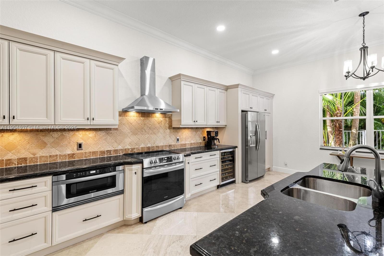 1967 Timberline Road Weston, FL 33327 - Photo 26 of 56 a kitchen with stainless steel appliances granite countertop a sink stove and refrigerator