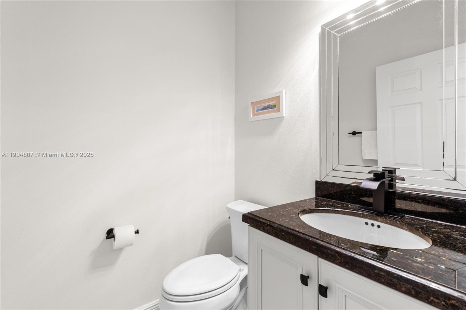 1967 Timberline Road Weston, FL 33327 - Photo 27 of 56 a bathroom with a granite countertop sink and a mirror