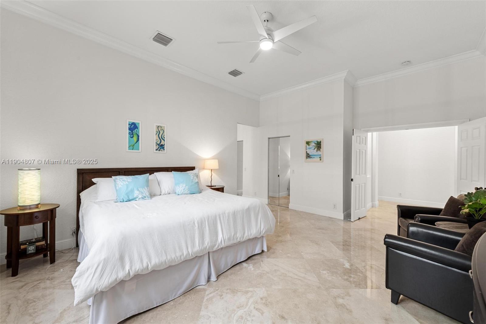 1967 Timberline Road Weston, FL 33327 - Photo 29 of 56 a bedroom with a bed and a chandelier