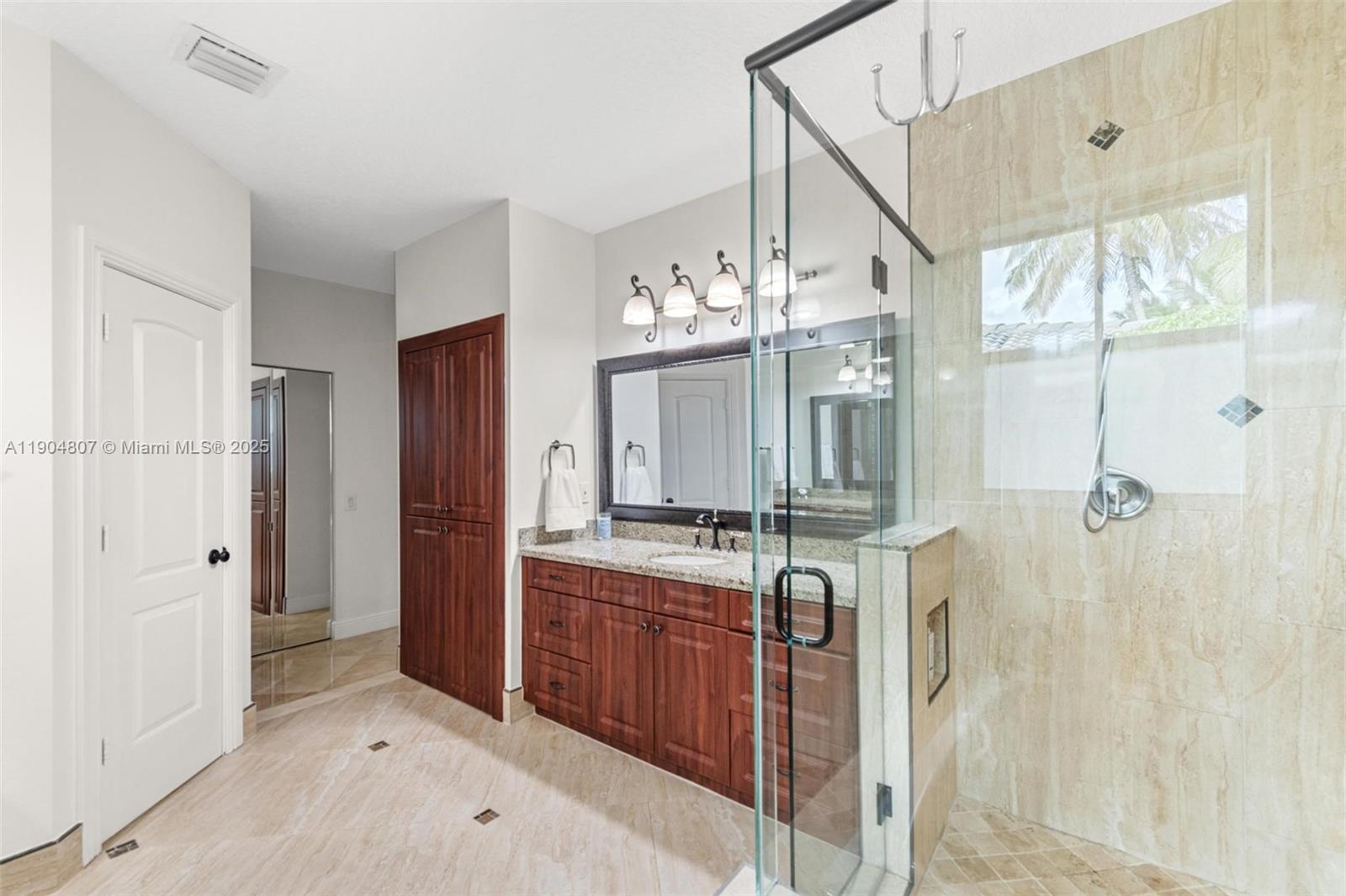 1967 Timberline Road Weston, FL 33327 - Photo 32 of 56 a bathroom with a granite countertop sink a large mirror and a shower