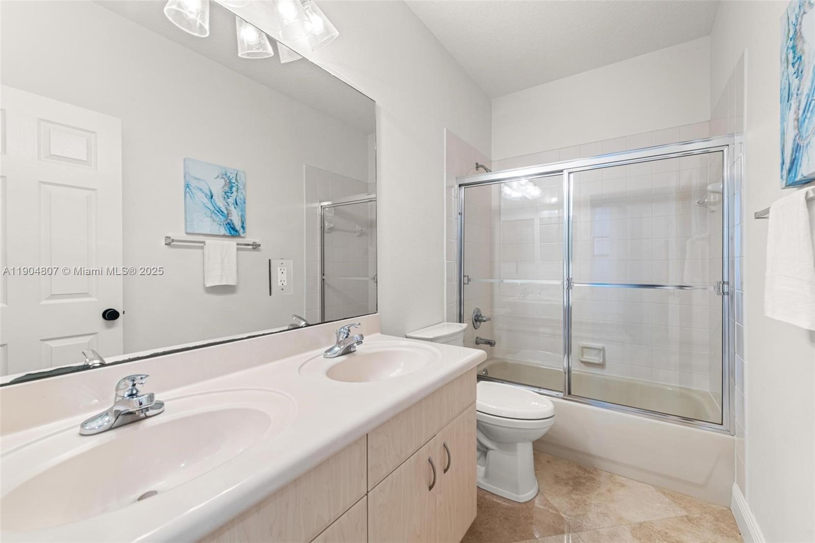 1967 Timberline Road Weston, FL 33327 - Photo 34 of 56 a bathroom with a double vanity sink toilet and shower