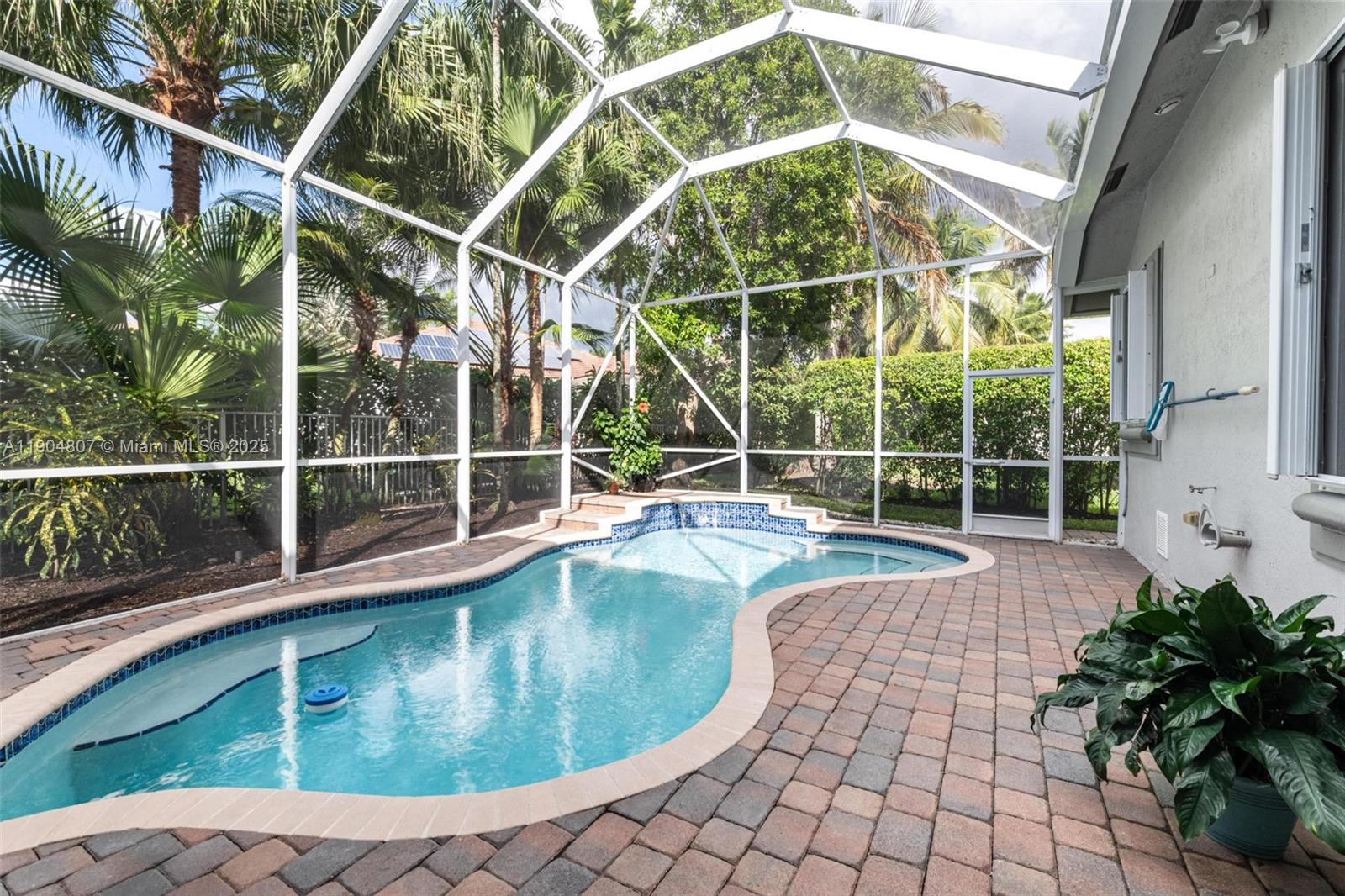 1967 Timberline Road Weston, FL 33327 - Photo 40 of 56 a view of a house with a swimming pool