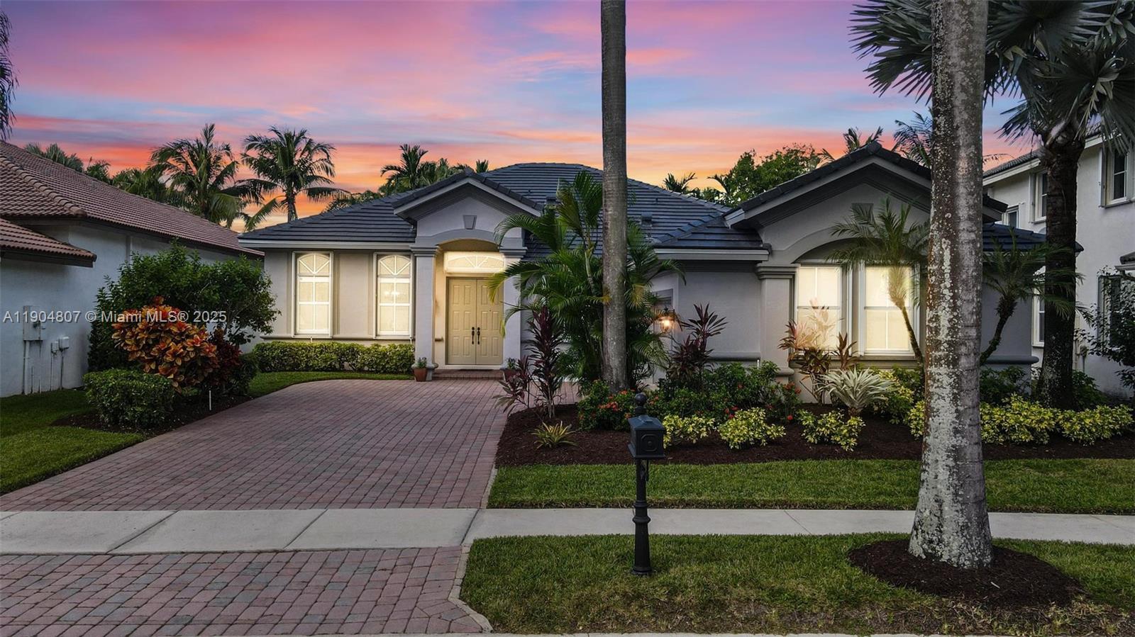 1967 Timberline Road Weston, FL 33327 - Photo 5 of 56 a front view of a house with a yard and potted plants