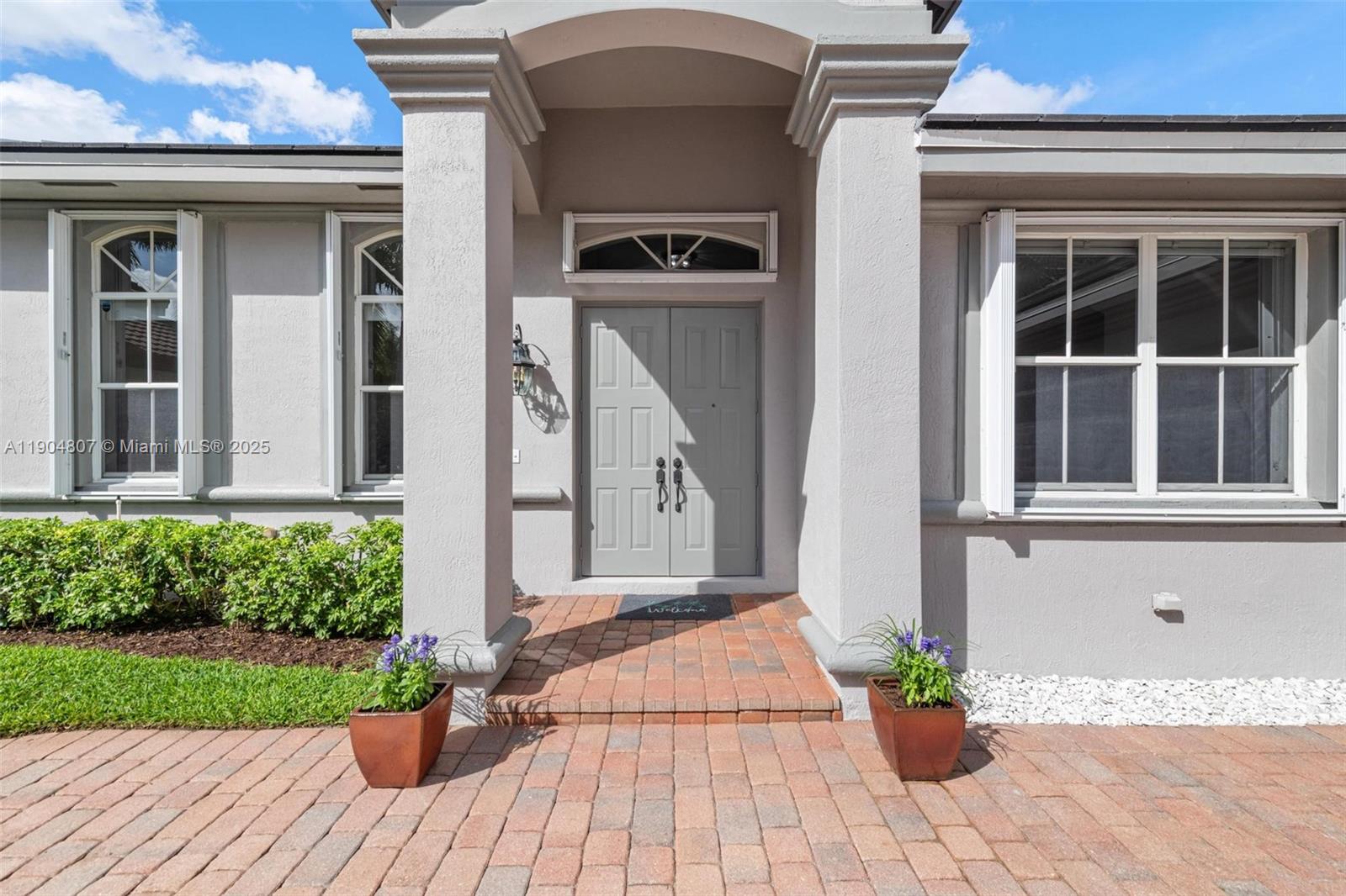 1967 Timberline Road Weston, FL 33327 - Photo 7 of 56 a front view of a house with a yard