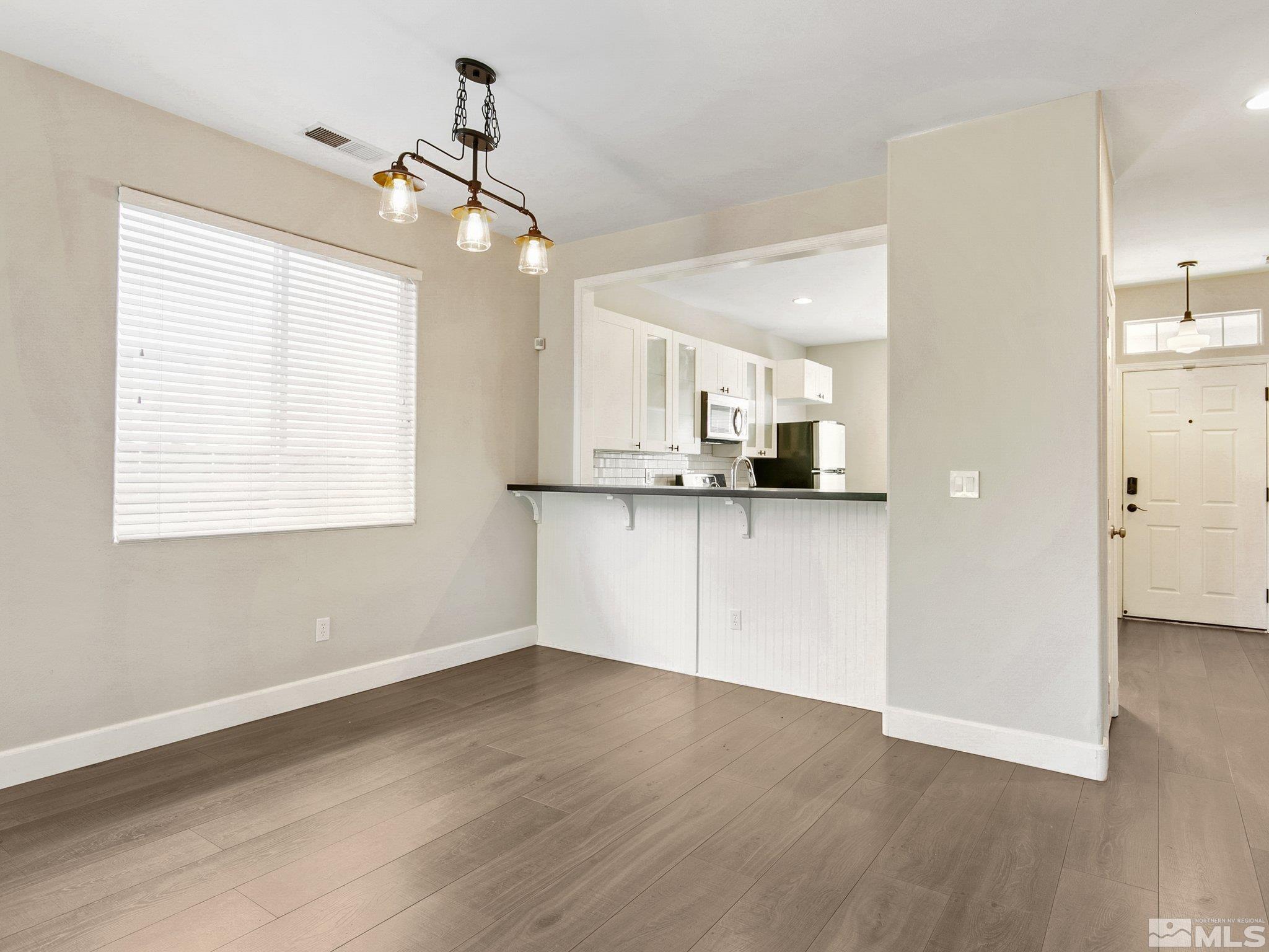 2348 Clementine Lane Reno, NV 89521 - Photo 14 of 38 a view of a kitchen with wooden floor and a window