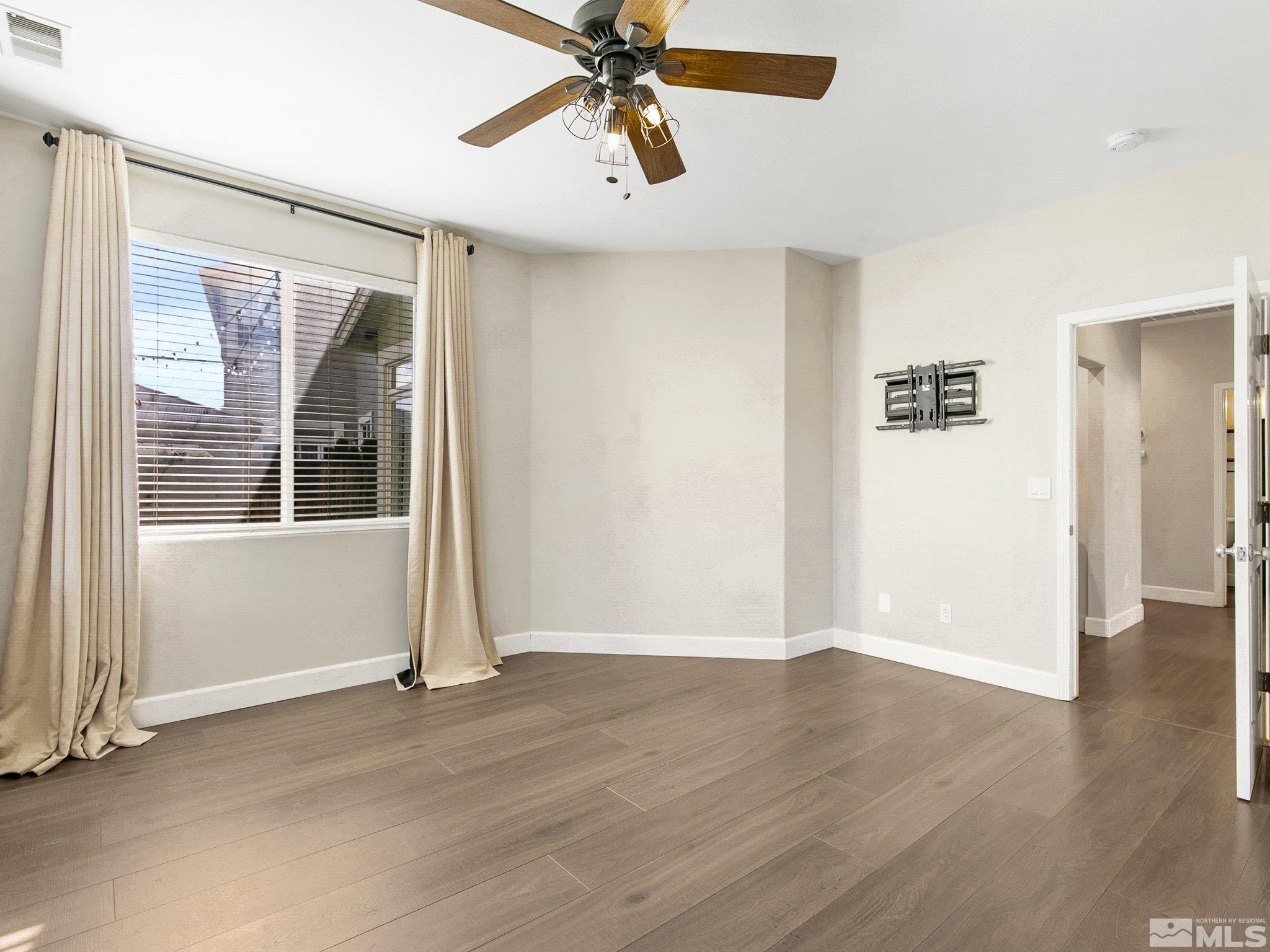 2348 Clementine Lane Reno, NV 89521 - Photo 19 of 38 a view of an empty room with wooden floor and a window