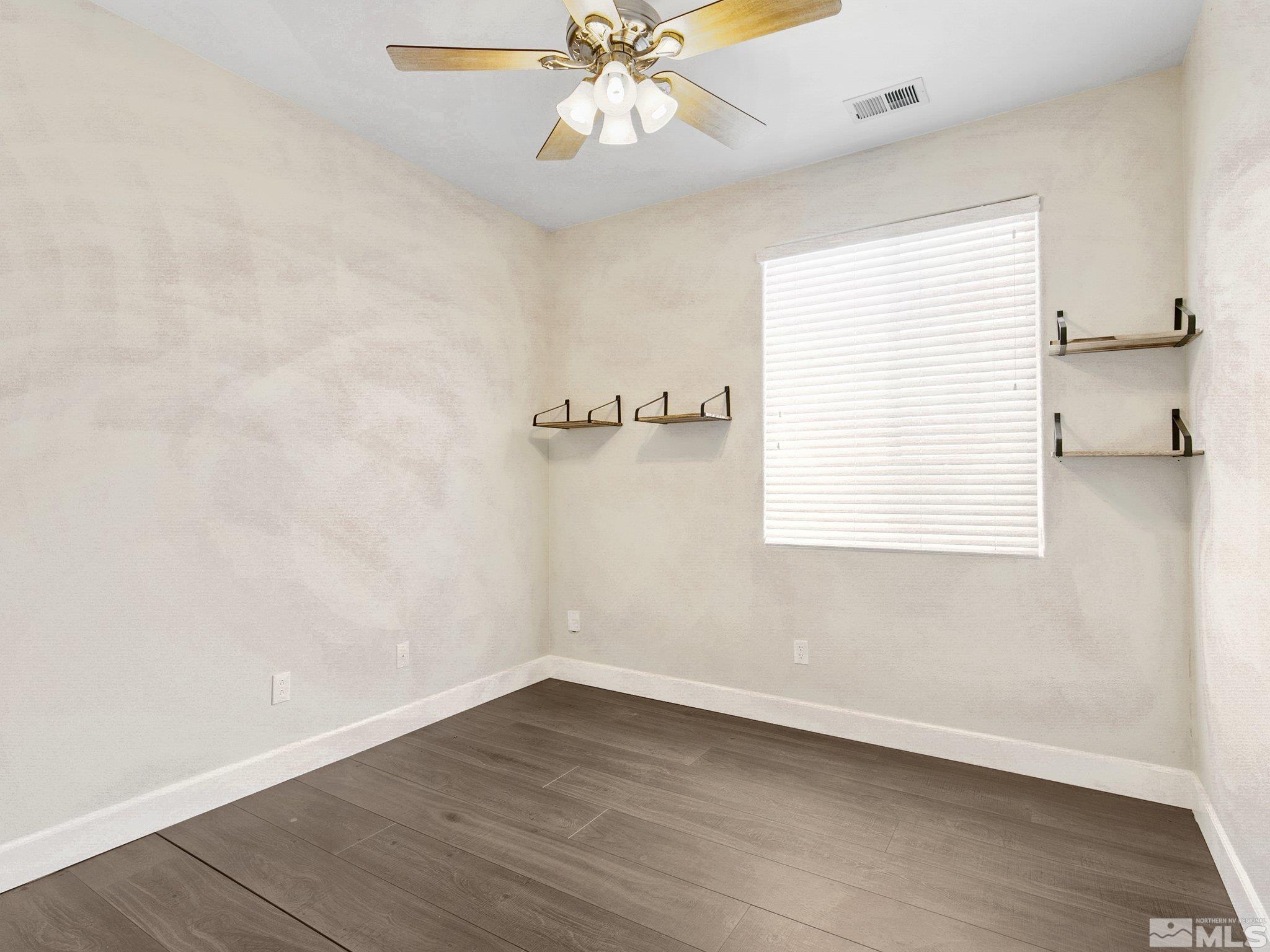 2348 Clementine Lane Reno, NV 89521 - Photo 25 of 38 wooden floor in an empty room with a window