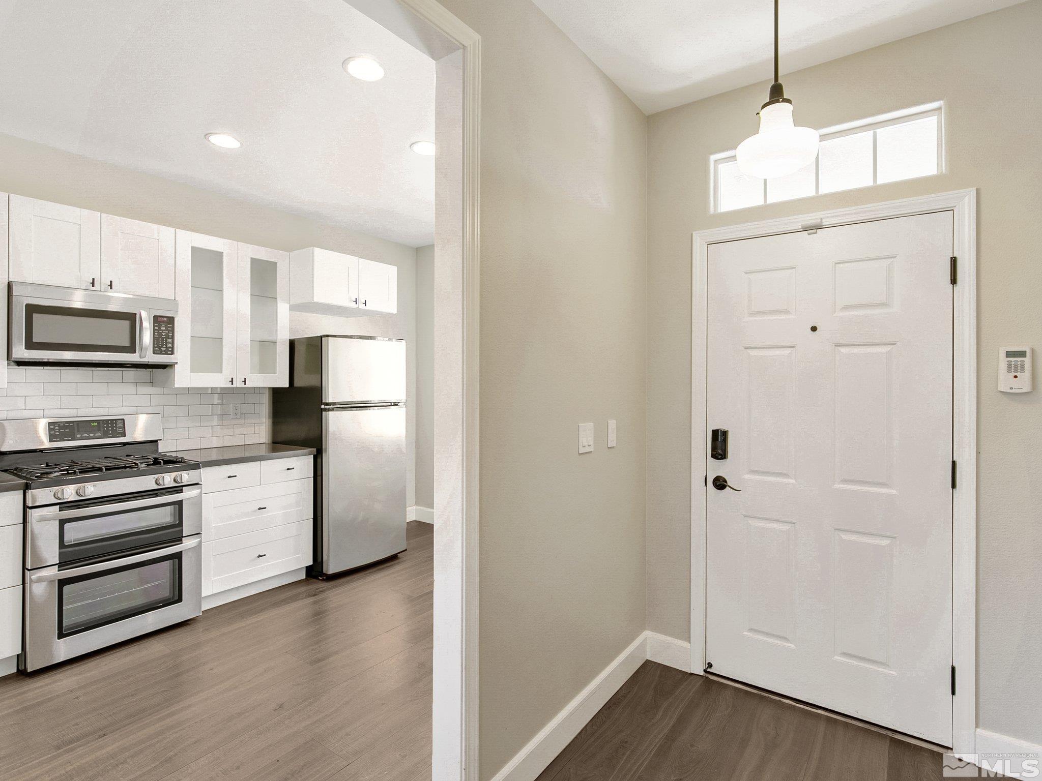 2348 Clementine Lane Reno, NV 89521 - Photo 9 of 38 a kitchen with a refrigerator stove and wooden floor