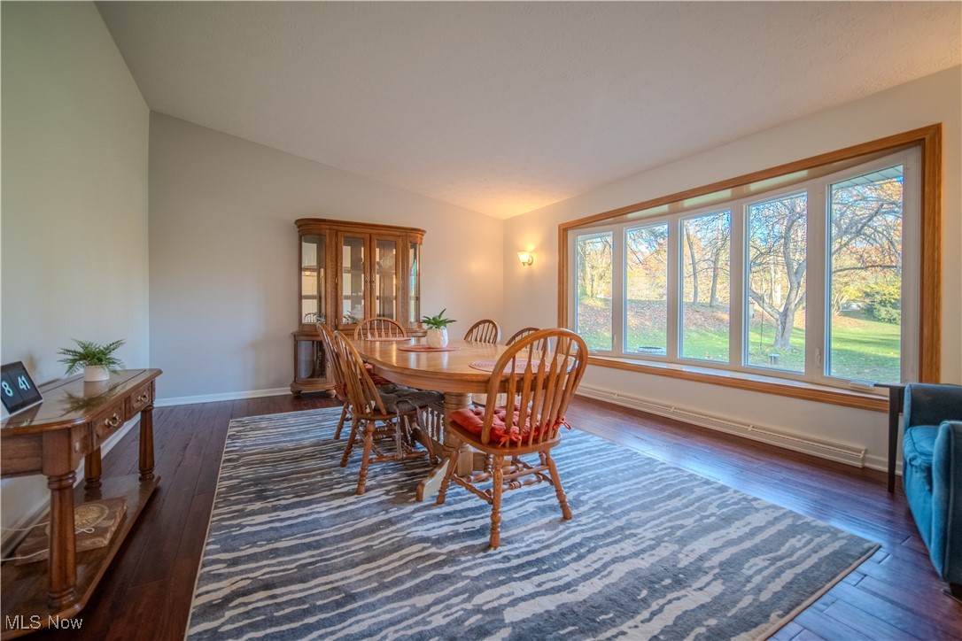 1394 Saxe Road Mogadore, OH 44260 - Photo 8 of 39 Dining area featuring dark wood-style floors and vaulted ceiling