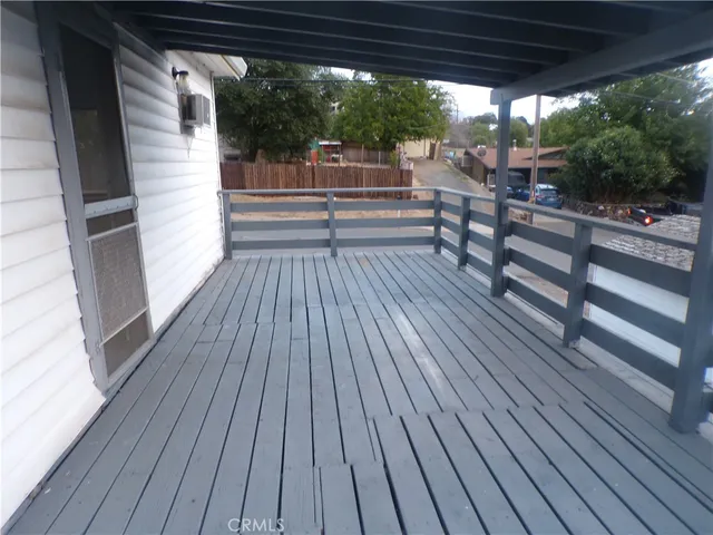a view of a balcony with wooden floor