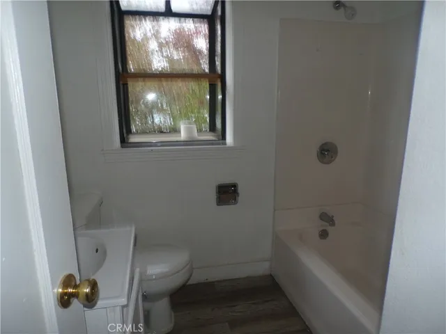 a bathroom with a toilet and a tub