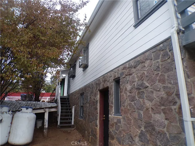 a view of patio with chairs and potted plants