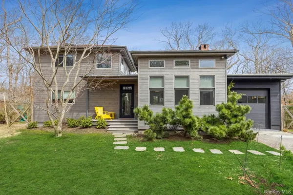 a front view of a house with a garden