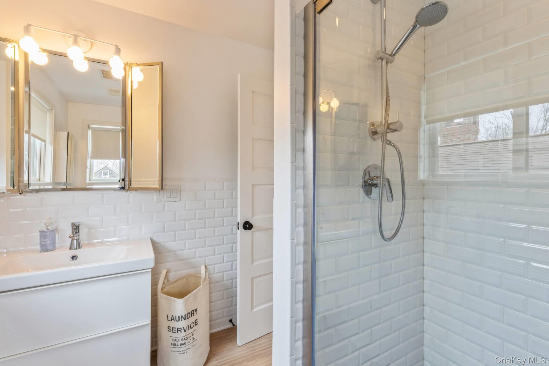 85 Camberly Road East Hampton, NY 11937 - Photo 11 of 17 a bathroom with a granite countertop shower a sink and a mirror