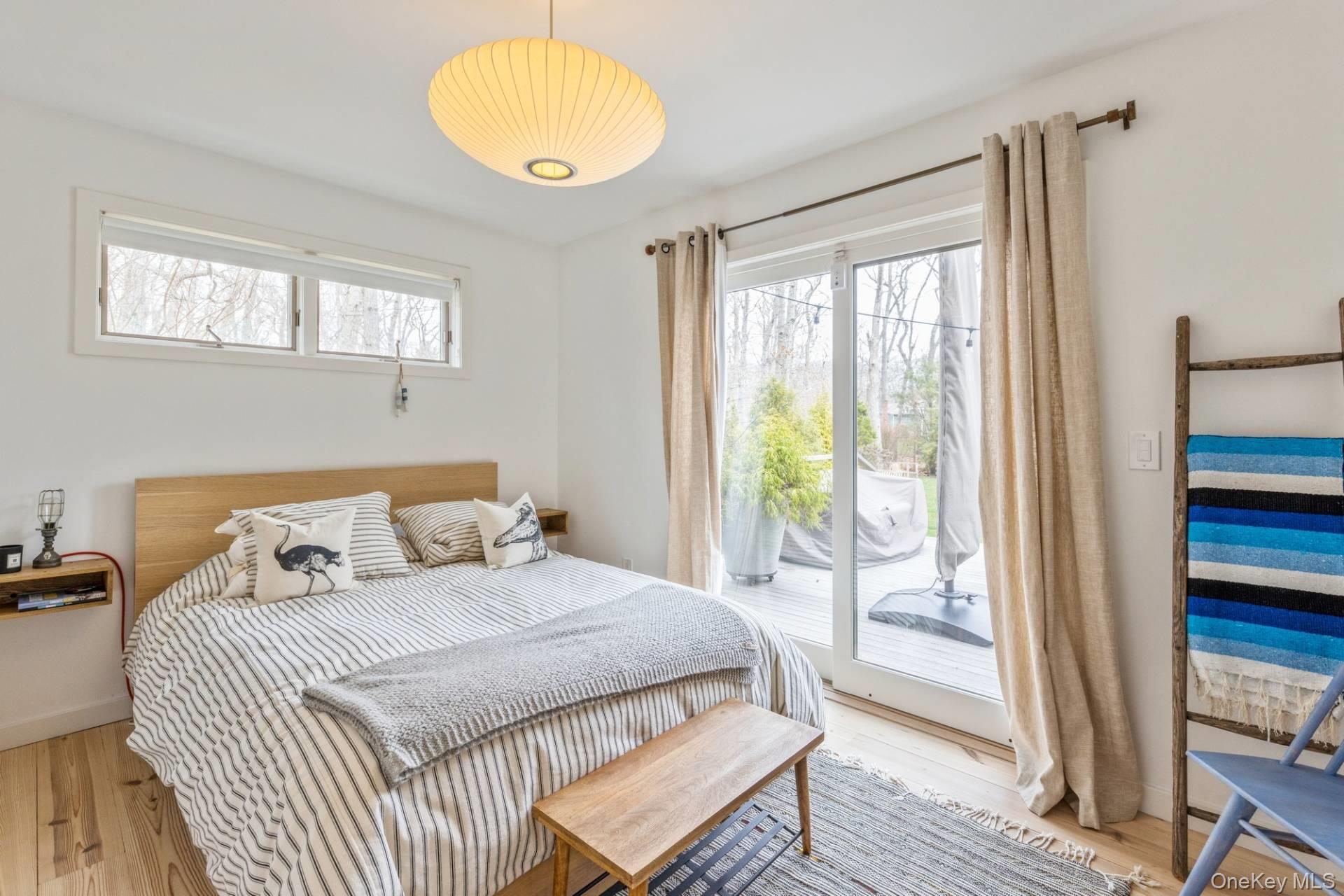 85 Camberly Road East Hampton, NY 11937 - Photo 12 of 17 a bedroom with a bed and wooden floor