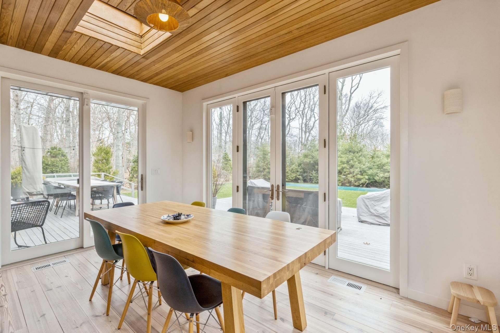 85 Camberly Road East Hampton, NY 11937 - Photo 8 of 17 a view of a dining room with furniture window and outside view
