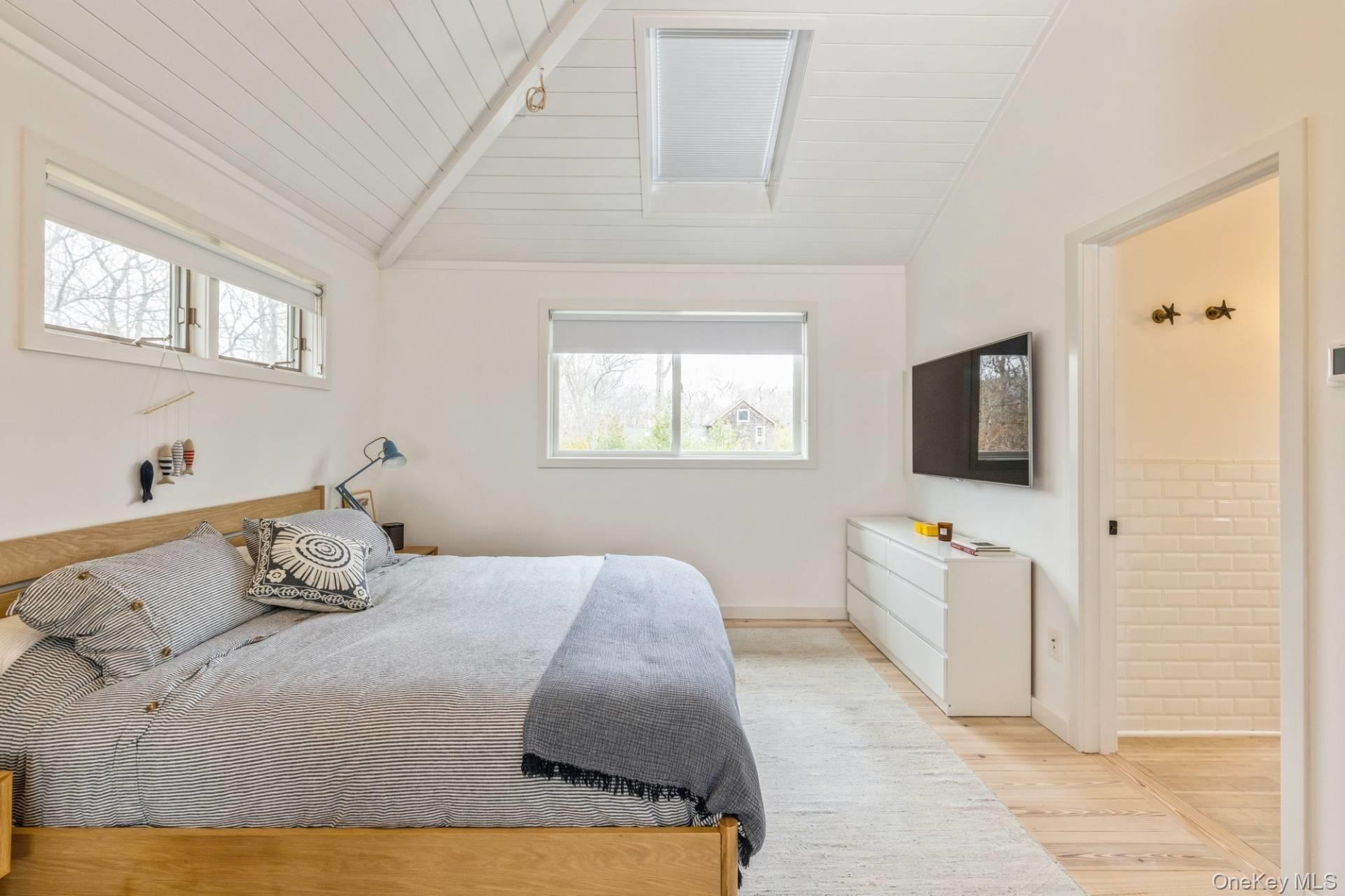 85 Camberly Road East Hampton, NY 11937 - Photo 10 of 17 a bedroom with a bed and flat screen tv