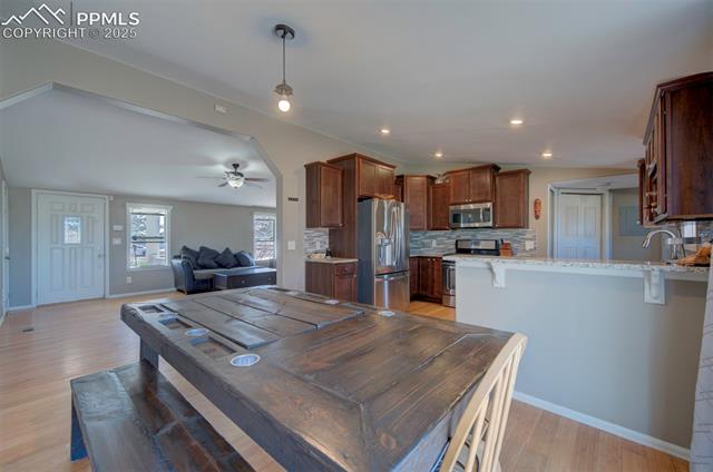 5860 Curtis Road Peyton, CO 80831 - Photo 12 of 28 Dining space featuring recessed lighting, baseboards, light wood-type flooring, and ceiling fan